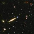 Edge-On Spiral Galaxy Collides With Small Blue Galaxy in Hubble Ultra Deep Field Image