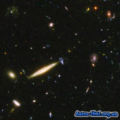 Edge-On Spiral Galaxy Collides With Small Blue Galaxy in Hubble Ultra Deep Field Image